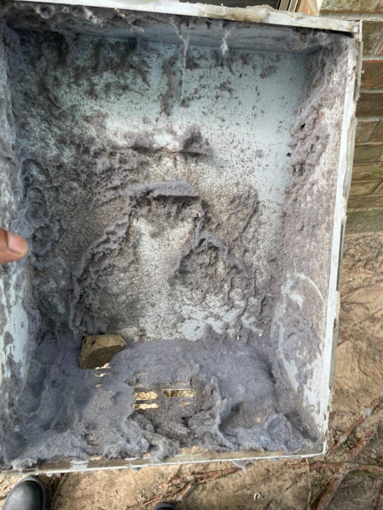 Dryer vent transition box full of lint buildup before professional cleaning in Brookshire, TX 77423