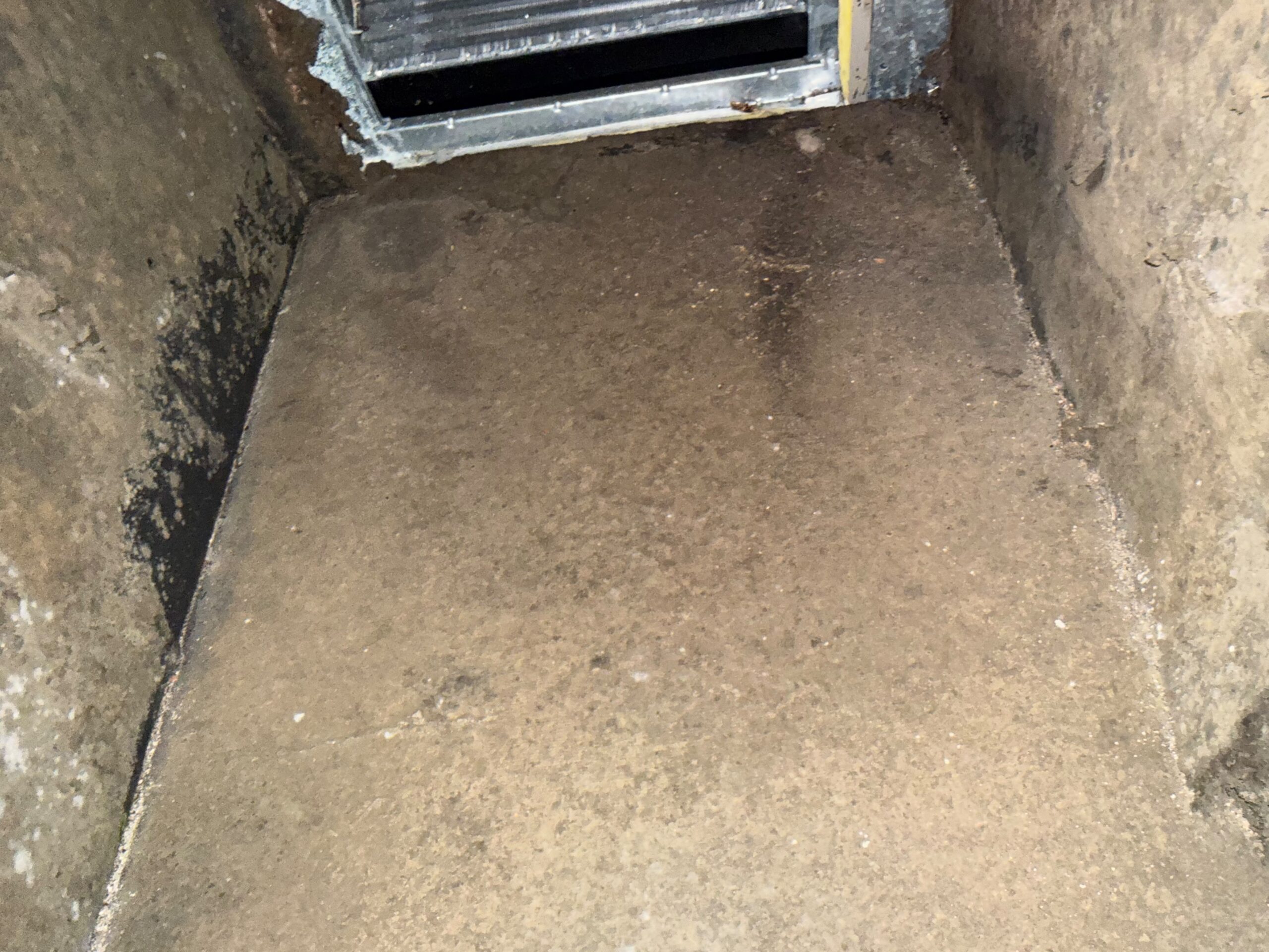 HVAC plenum floor cleaned after professional duct service