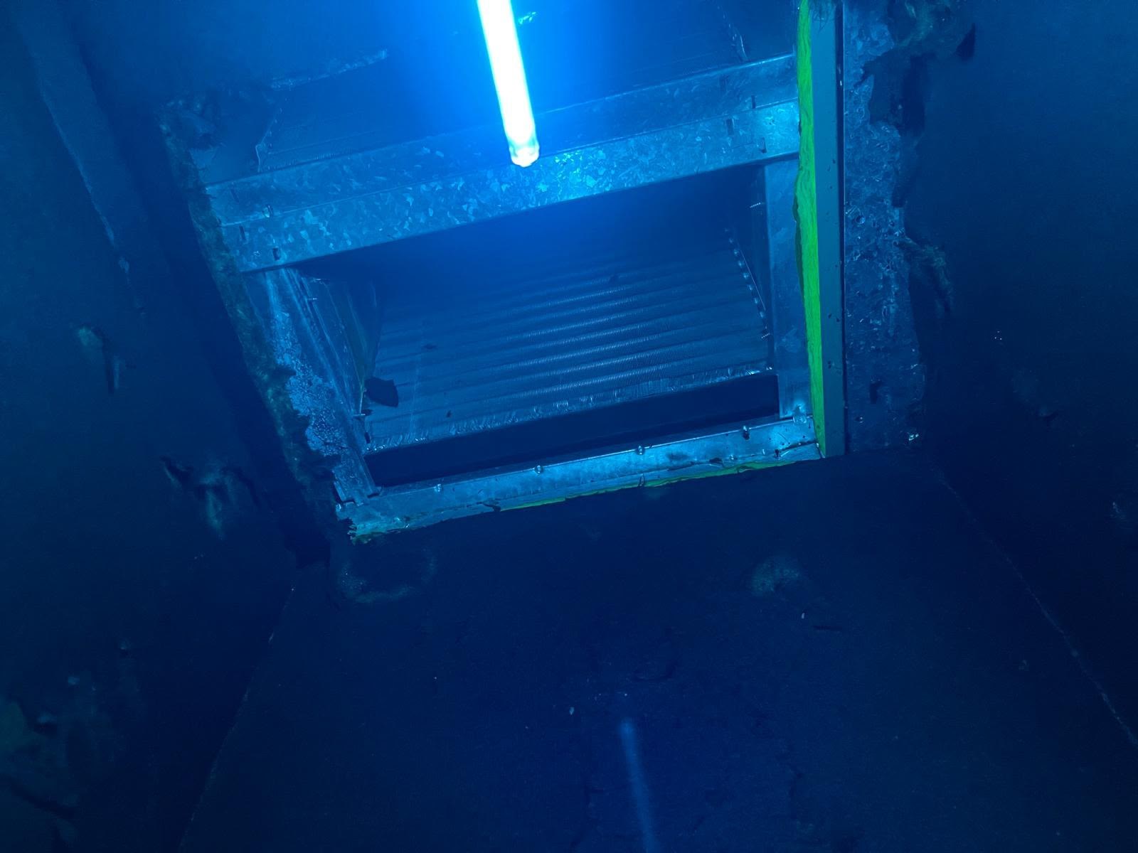 UV air purifier operating inside the HVAC system, blue light visible