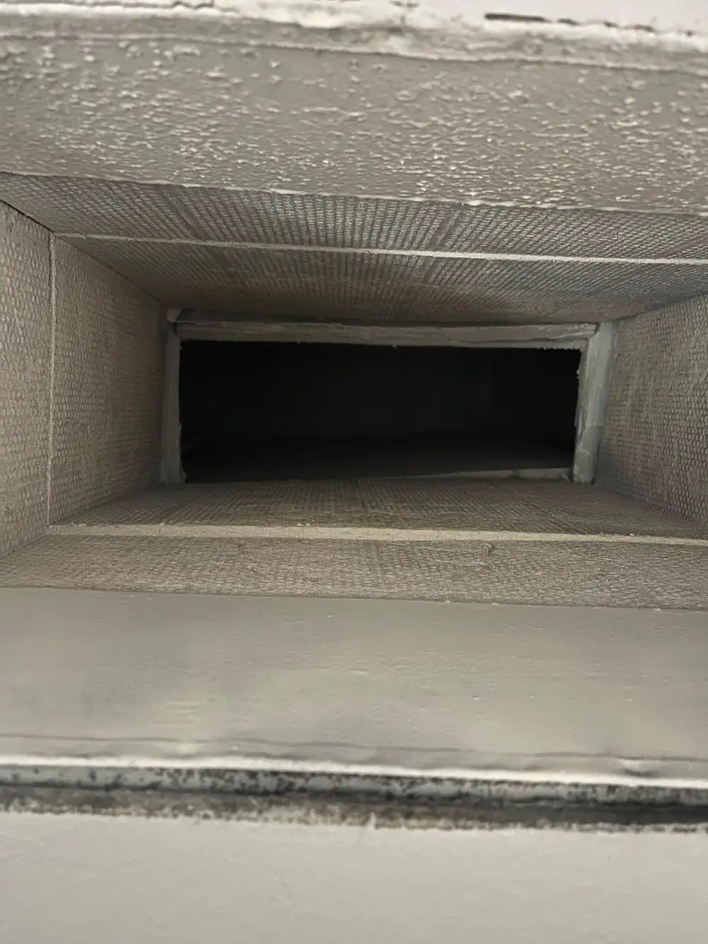 Clean duct board plenum after professional cleaning and Foster 40-20 application in Katy TX