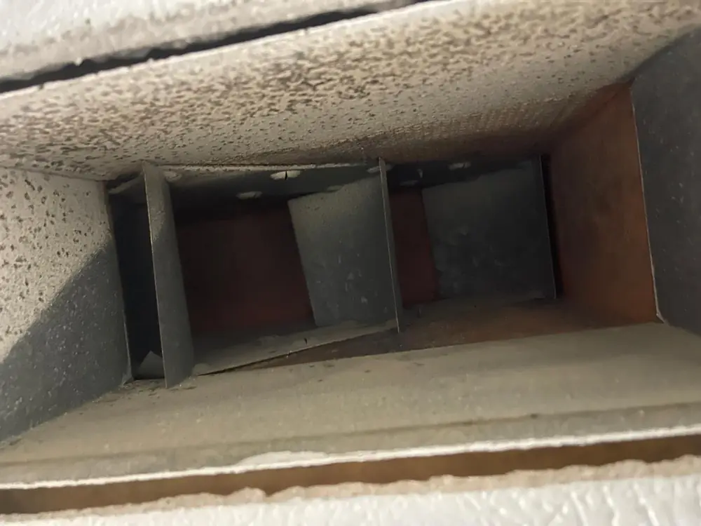 Duct board supply trunk with dust and debris buildup before professional air duct cleaning in Katy TX