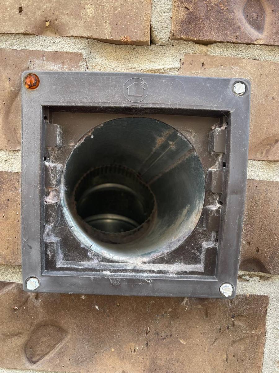 Exterior dryer vent wall cap with lint before cleaning in Richmond TX