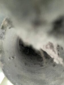 Dryer vent packed with lint buildup before cleaning in Richmond TX 77407