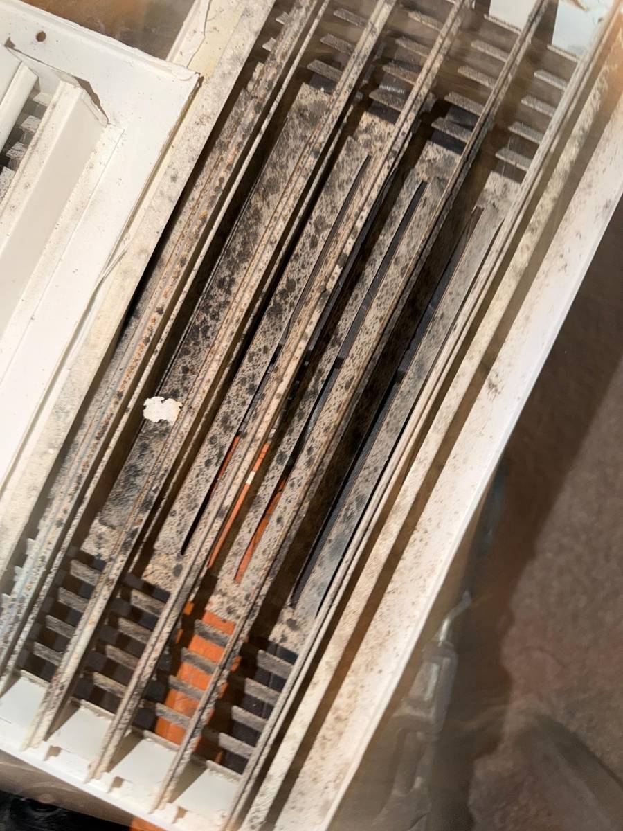 Moldy supply register and louvers before air duct cleaning in Richmond TX